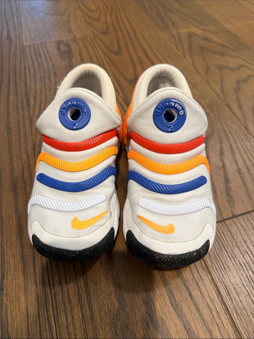 Nike Kids White Slip-On Sneakers with Orange, Blue & Yellow Accents